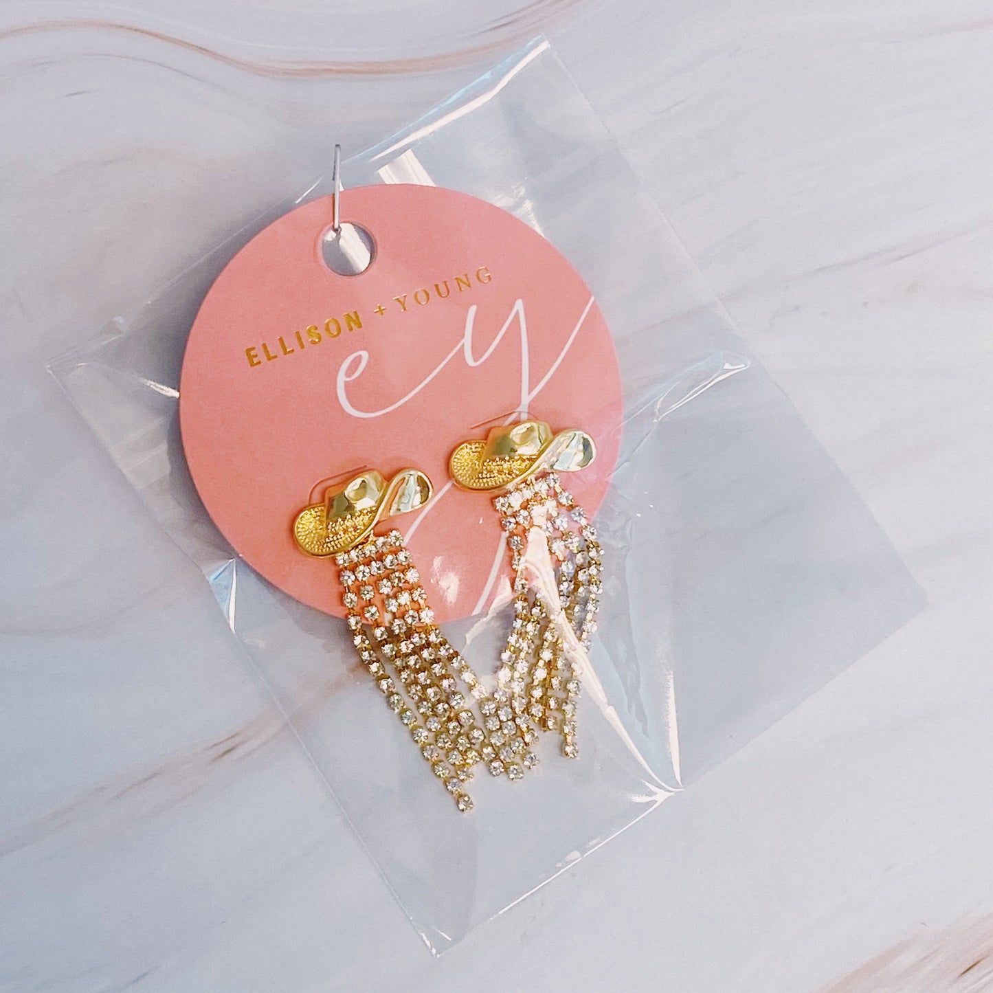 Sparkly cowboy hat fringe earrings that bring bold Western glam to any look.