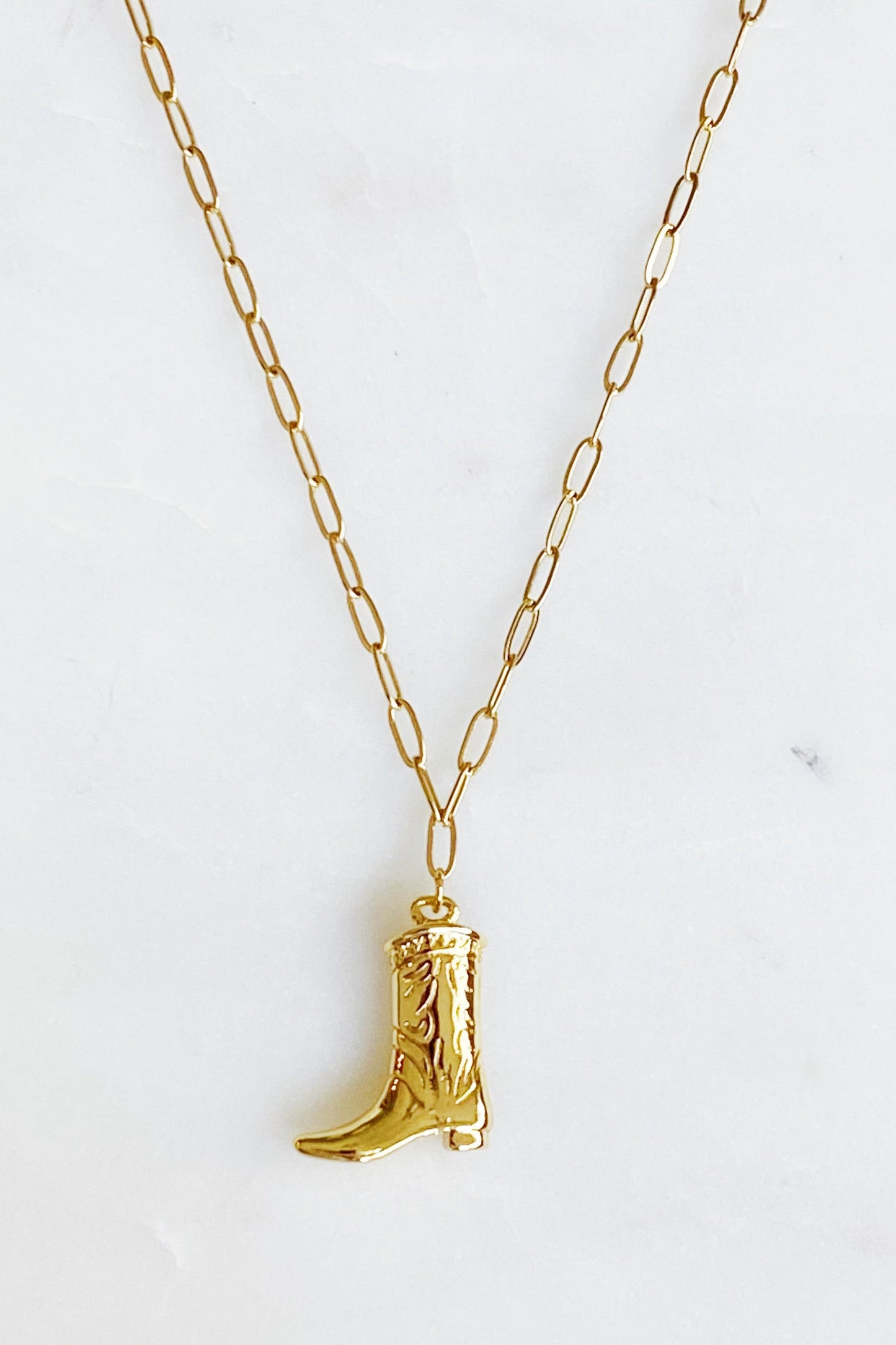 Gold cowgirl boot necklace with a detailed engraved pendant—your go-to piece for effortless Western style.