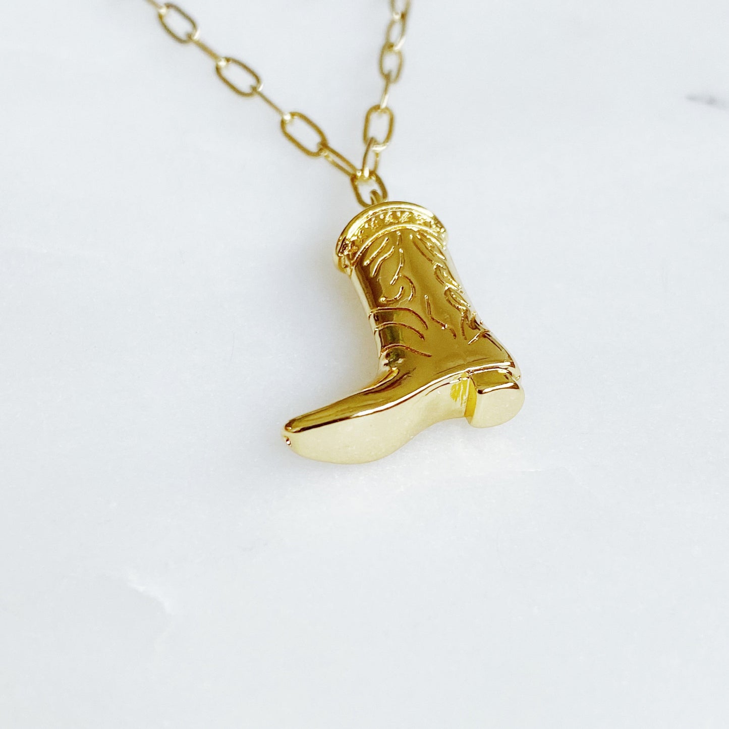 Gold cowgirl boot necklace with a detailed engraved pendant—your go-to piece for effortless Western style.