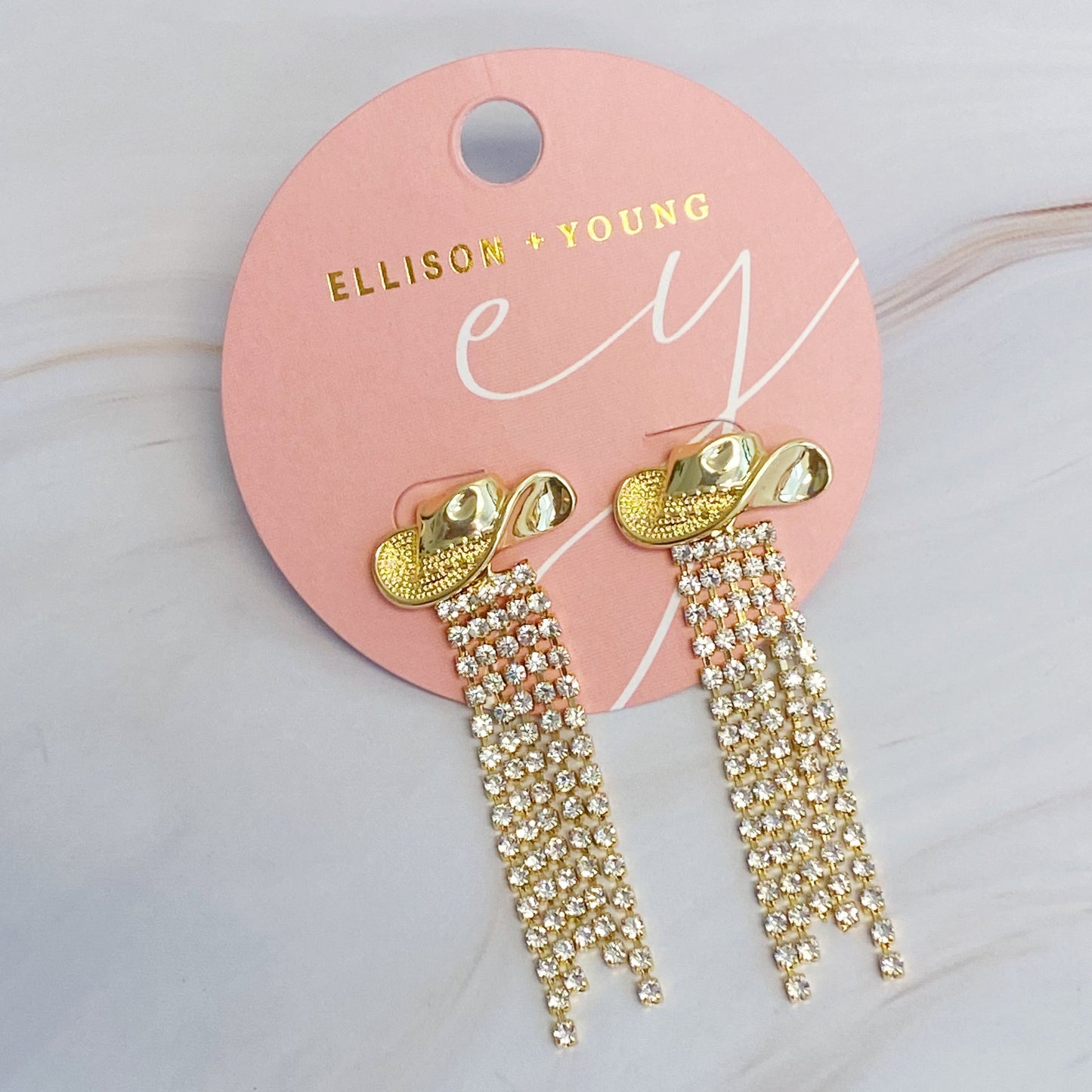 Sparkly cowboy hat fringe earrings that bring bold Western glam to any look.